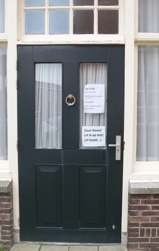 a closed black door sitting inside of a building