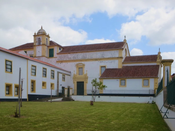 an old, white building on a very wide lawn