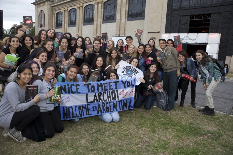 a group of people holding up signs and a sign