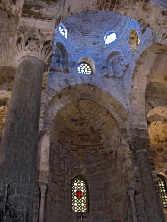 inside of a very ornate building with multiple stone columns