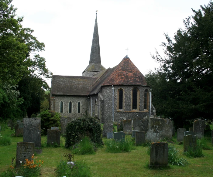 the old church has many graves and trees