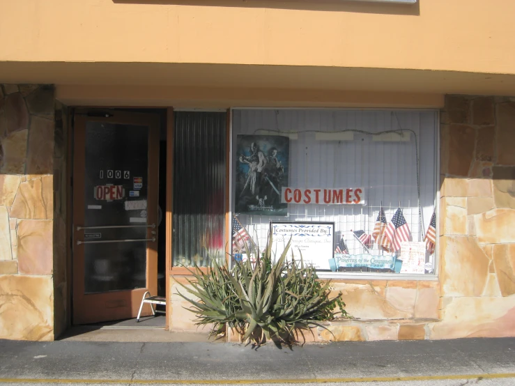 storefront window with poster on the front with cactus in it