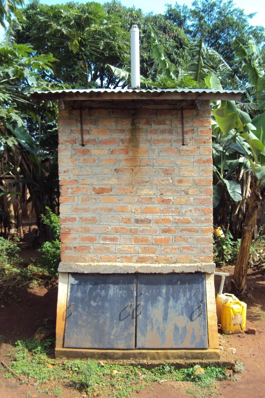 a brick stove sits outside in the middle of a field