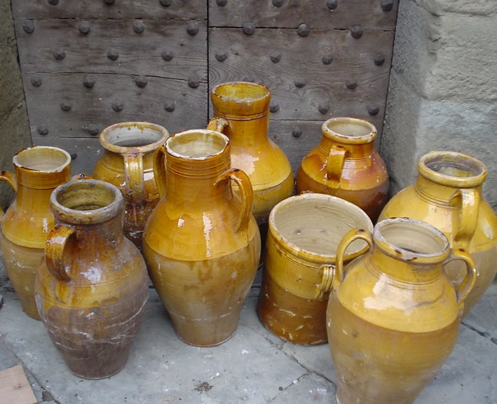 several brown and white vases sitting next to each other