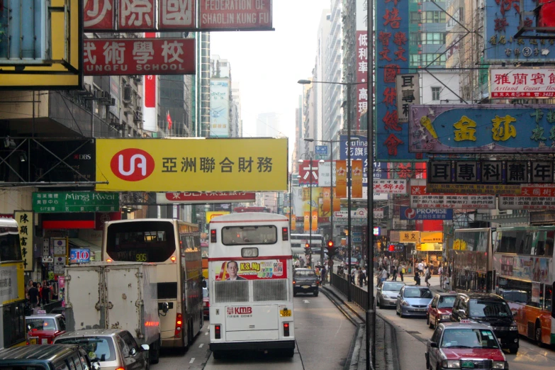 a busy street with a double decker bus in the middle