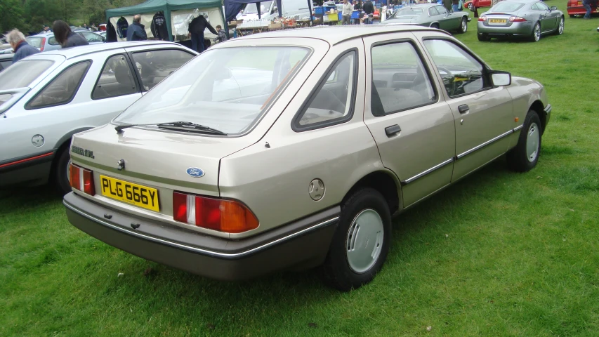 a grey car is parked in the grass