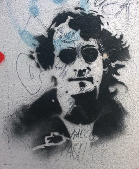 graffiti on a wall of a man with glasses