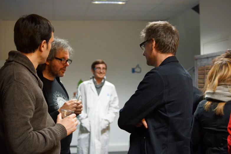 a group of people standing around talking