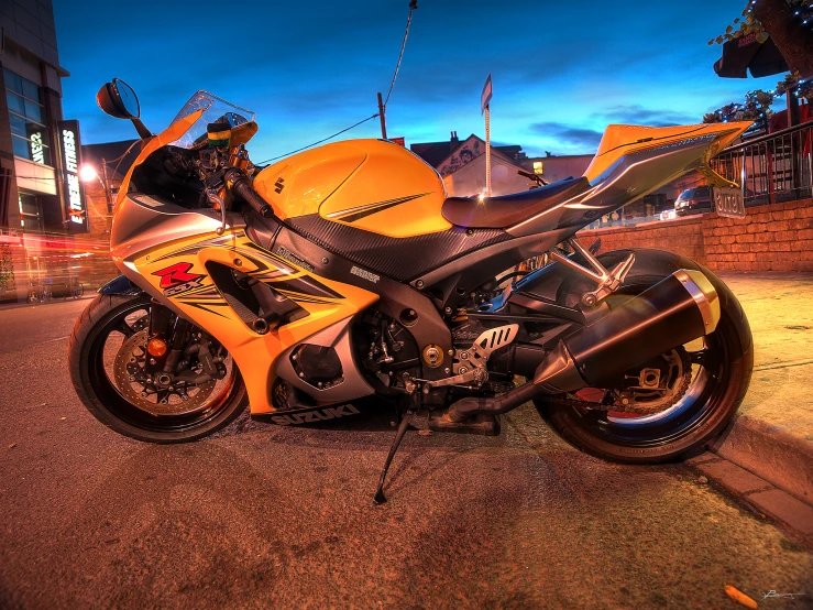 there is a yellow motorcycle parked in front of some buildings