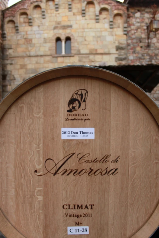 a wine barrel sitting next to a brick wall