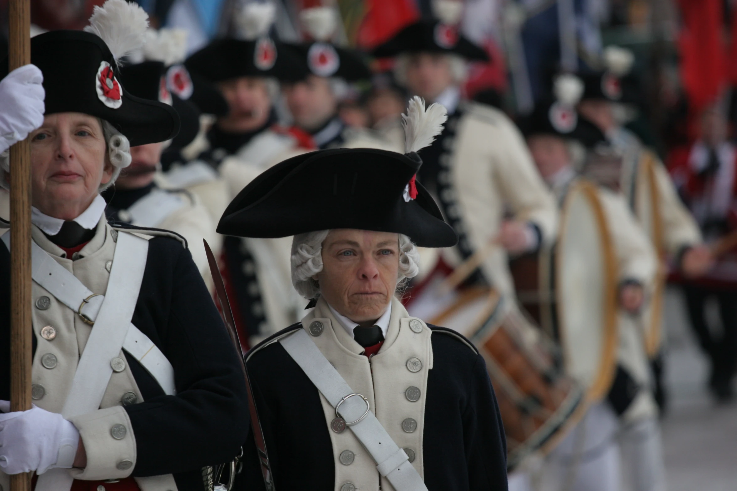 many men and women in costume stand beside each other