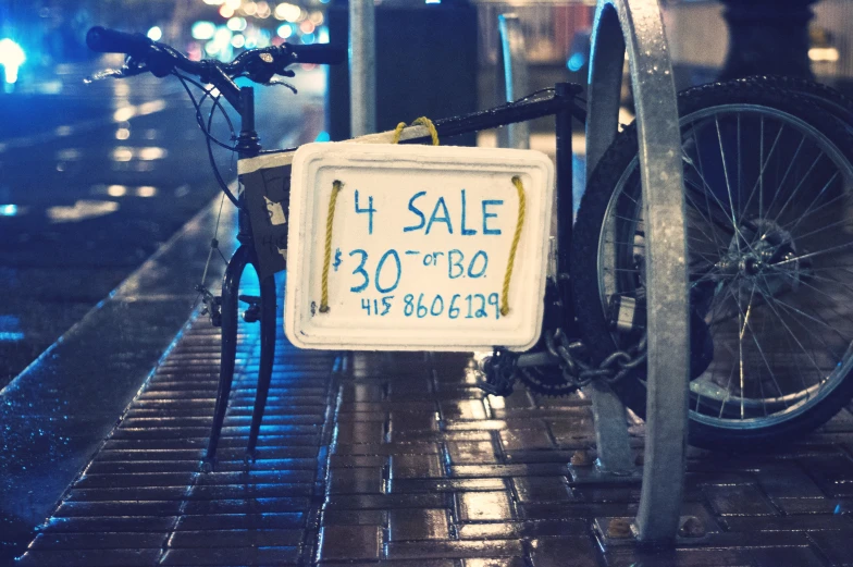 this is a bicycle and sign on the sidewalk