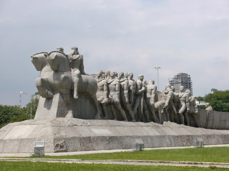 a statue of several men being separated by elephants