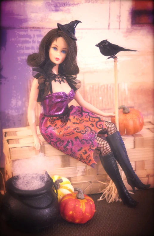 a barbie with halloween decorations, pumpkins and a cat