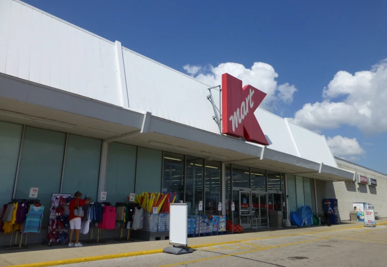 a view of a store front that contains clothing for sale