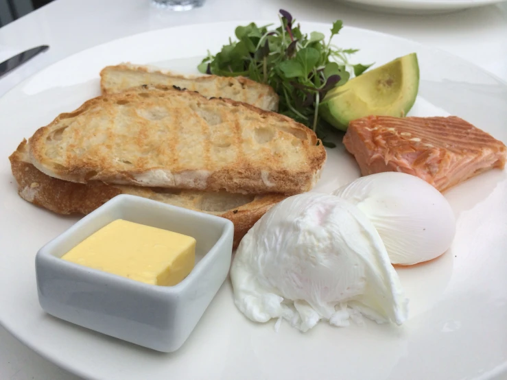 a white plate with food and some kind of knife