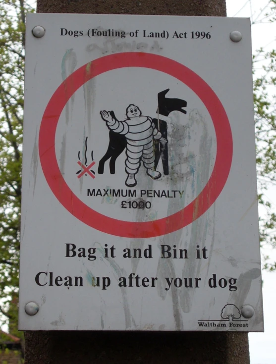 an animal warning sign posted outside on a post