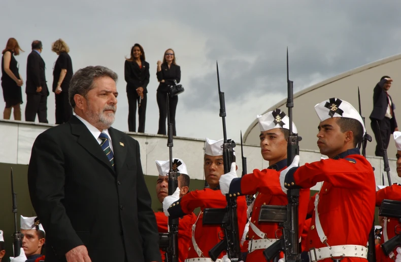 a band of men standing next to each other with people watching them