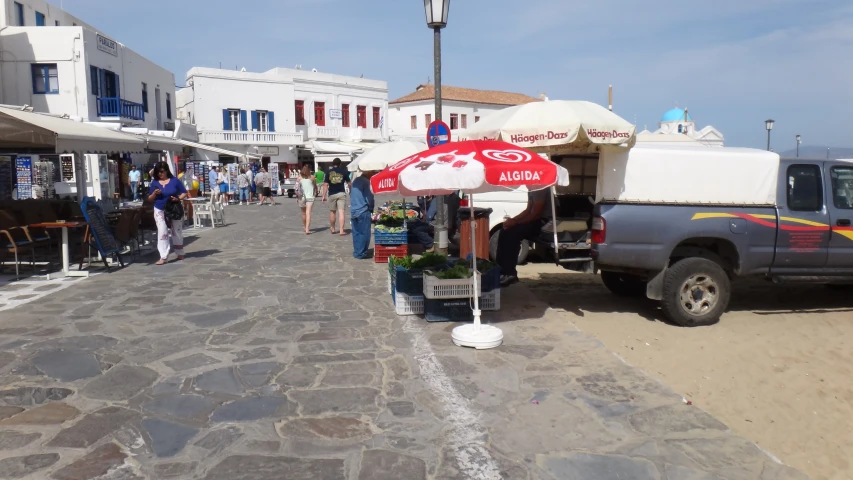 an outdoor street side market next to an ocean