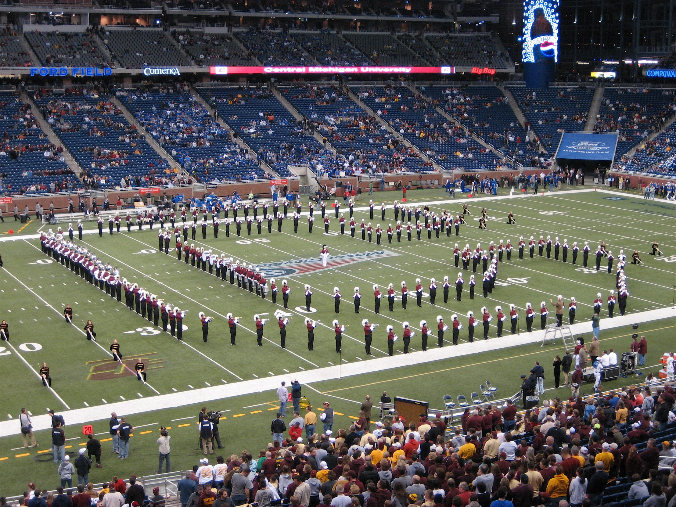 the band is on the field, and they are all wearing blue and yellow uniforms