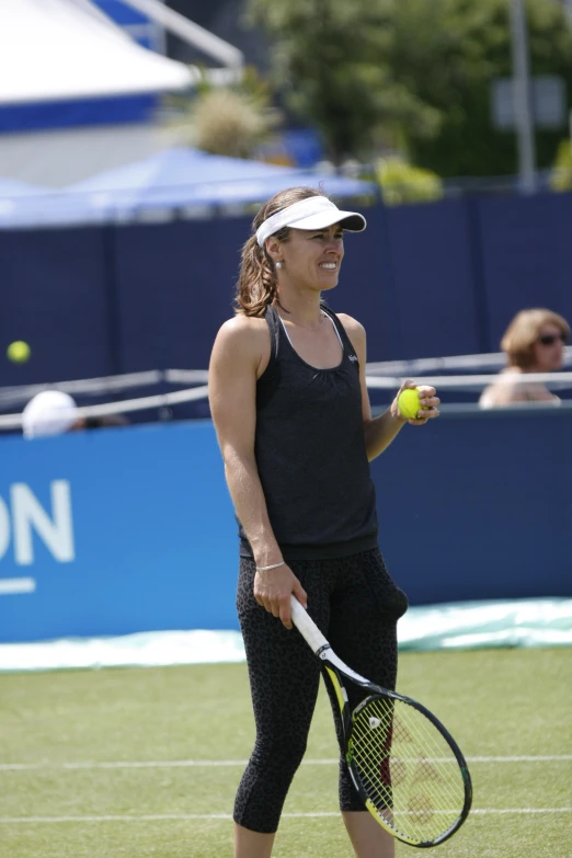 a woman standing on top of a tennis court holding a racquet