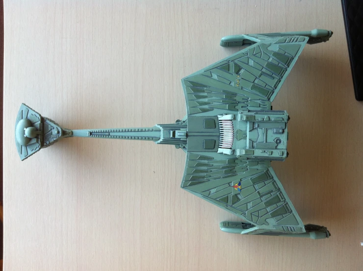 a star wars green sci - fim model with a laser pointer and keyboard