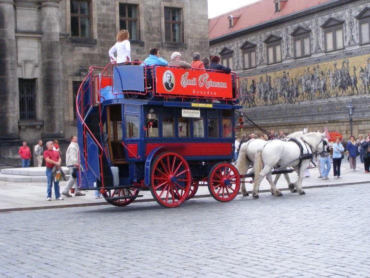 tourists ride in a horse - drawn carriage in the center of the old city