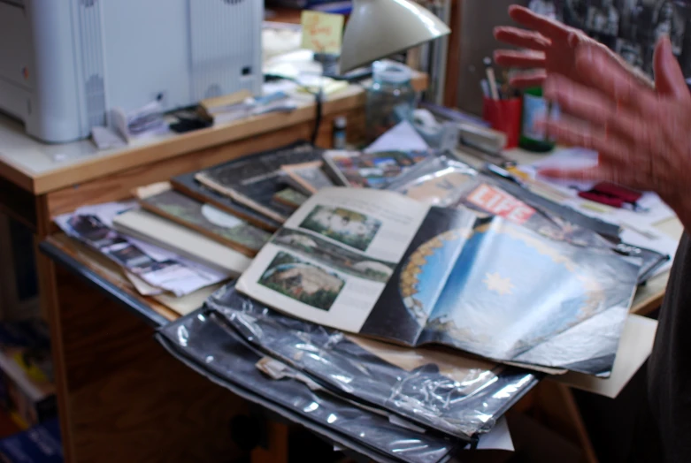 a desk filled with lots of junk and papers