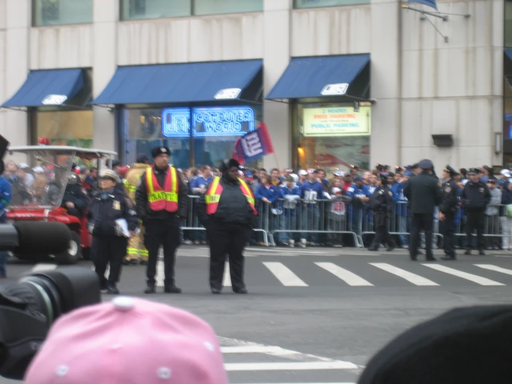 there are two police officers that have some people in the background