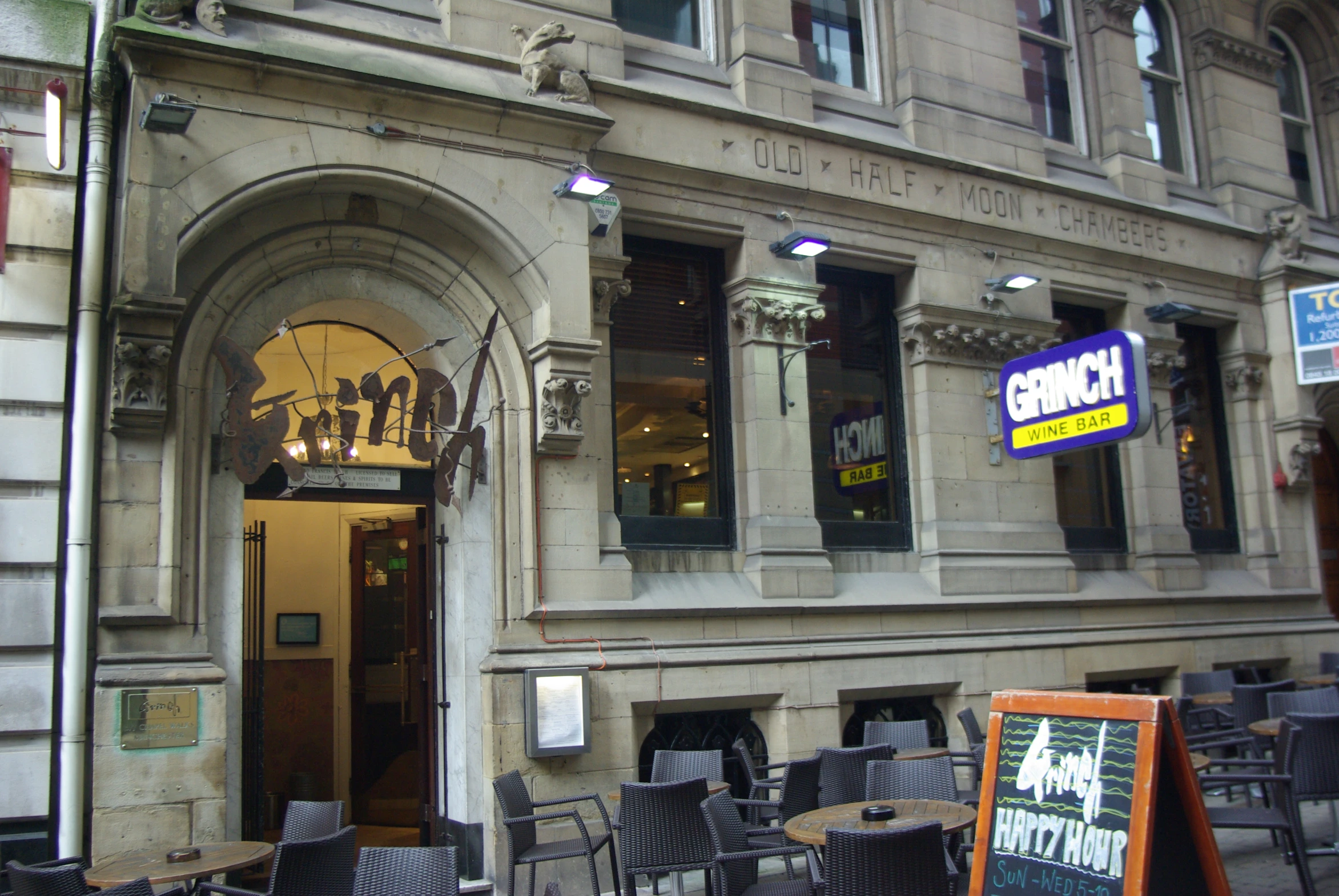 an outdoor restaurant with chairs and tables outside the building