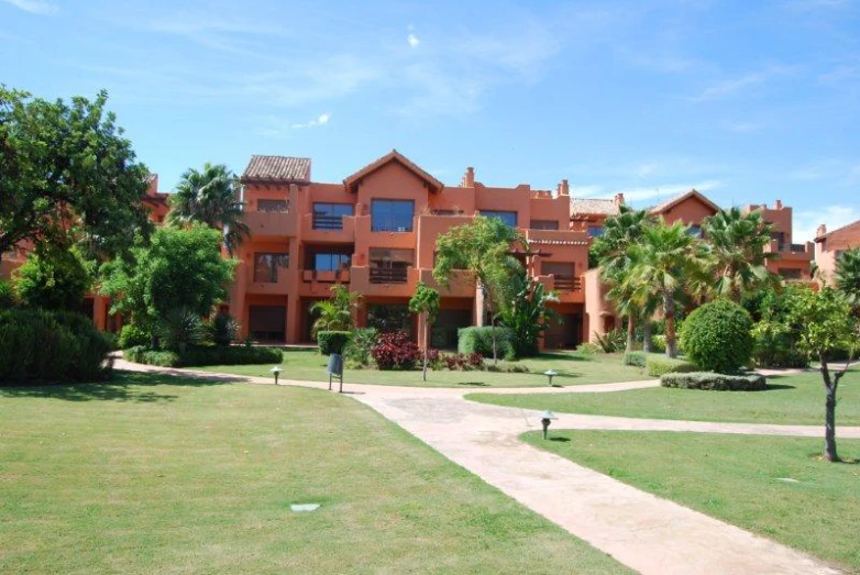 a lawn in front of a red building