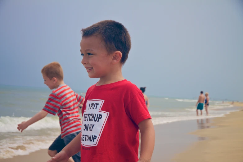 the boys are playing at the beach in the water