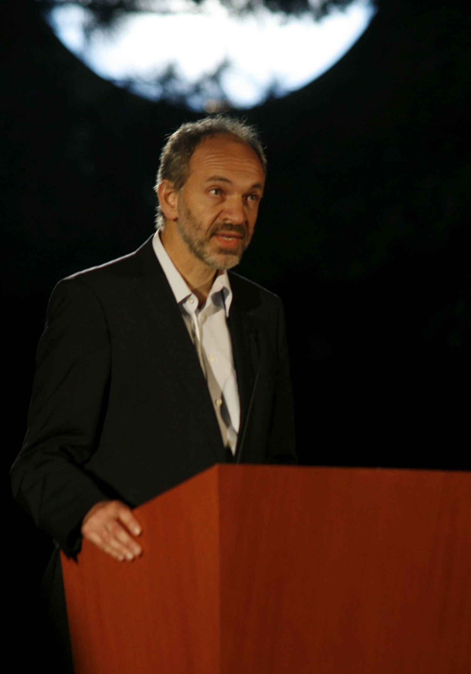 a man is standing behind a podium