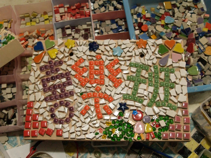 a group of letters on top of a pile of colorful tile