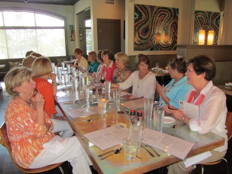 a group of women are sitting at a table