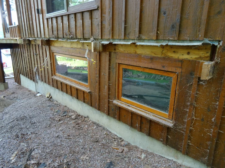 a side of a building with wooden siding