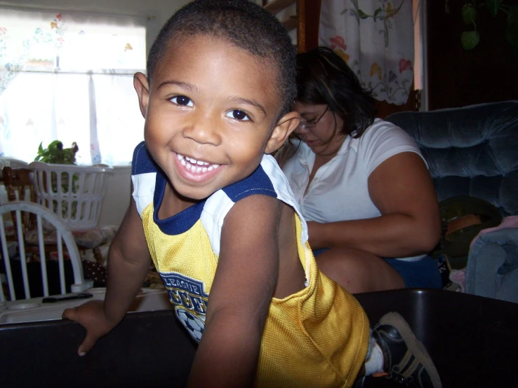 a little boy sitting in the middle of a living room