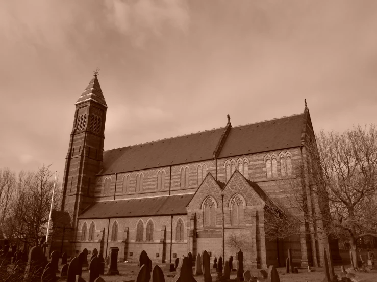 a graveyard with lots of tombstones near an old church