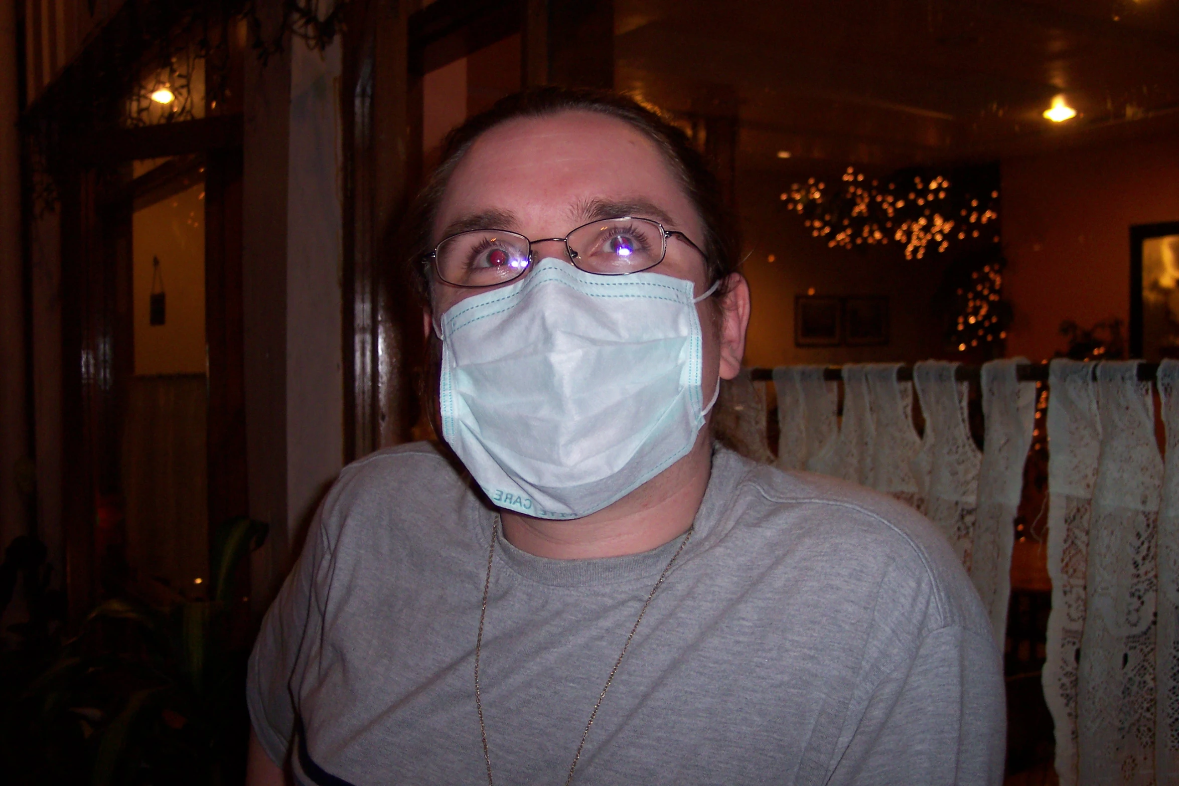 a man wearing a face mask and glowing glasses