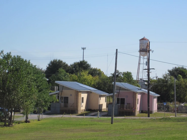 small building lined with trees and water tower