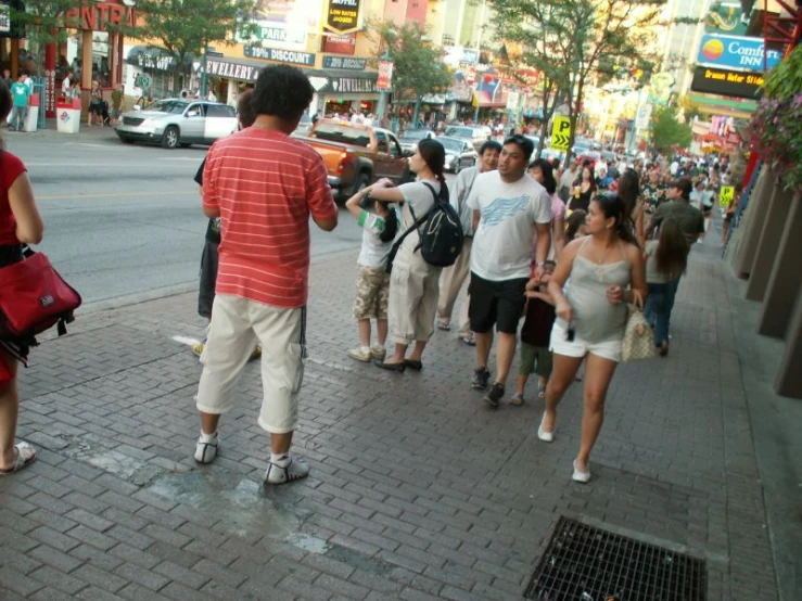 a crowd is walking down the street near people