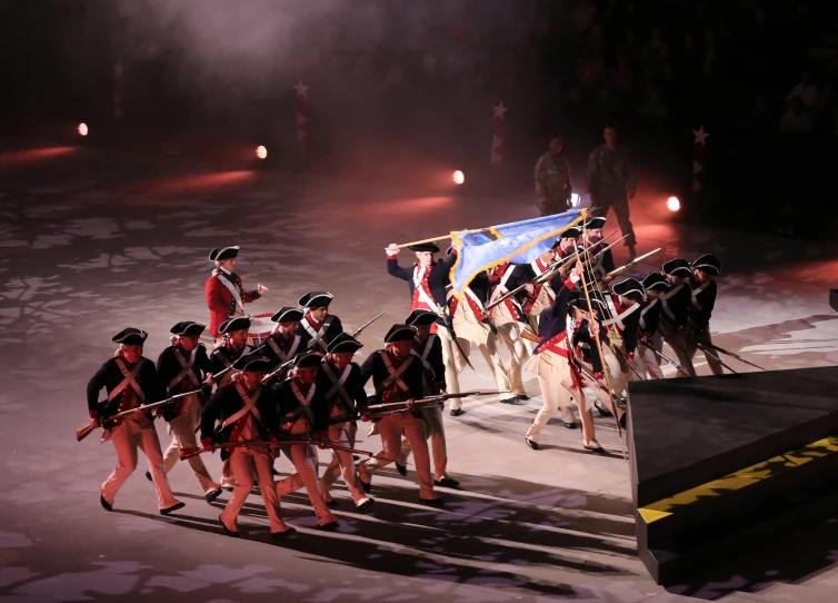 military officers marching down a street with one on the side