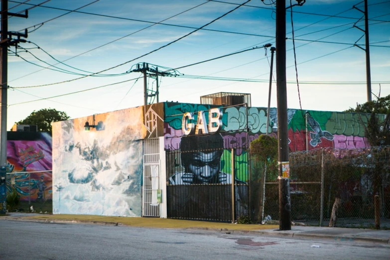 a wall with graffiti in different colors and designs