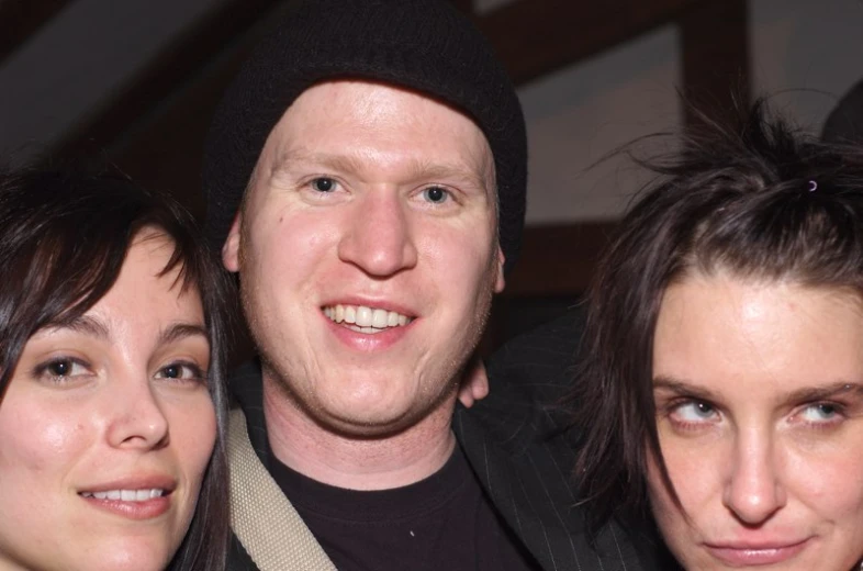 three people smiling for the camera