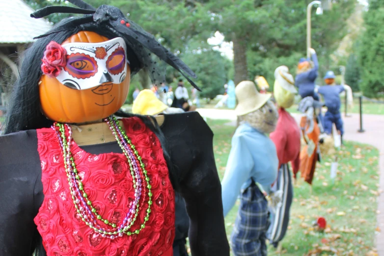 a pumpkin is the centerpiece in this group of halloween costumes