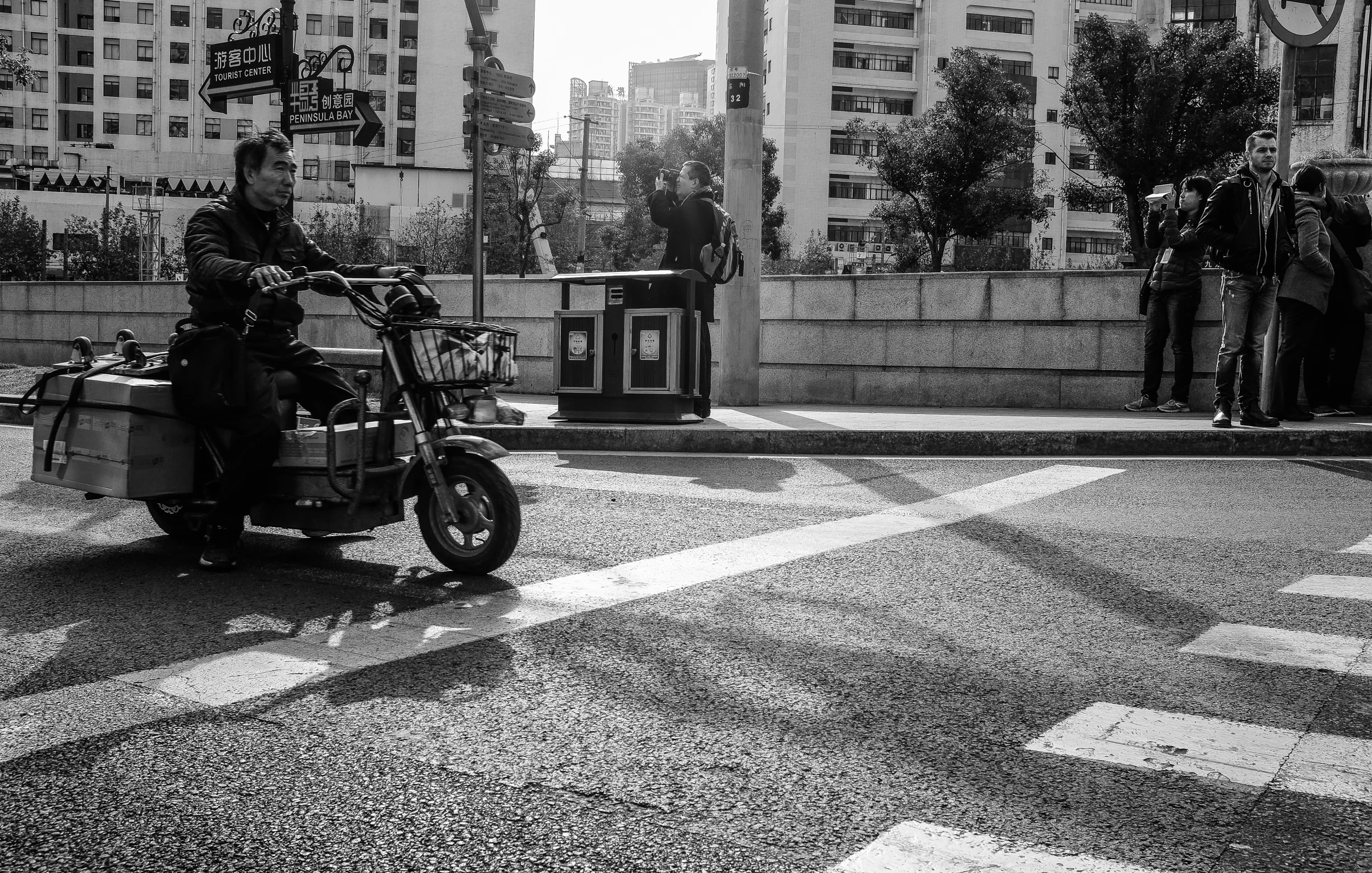 a person riding on the back of a motorcycle in a cross walk