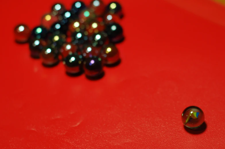 a pile of metallic balls on top of a table