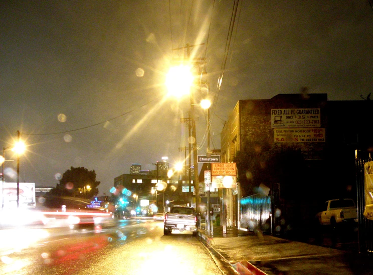 cars drive through the city at night time