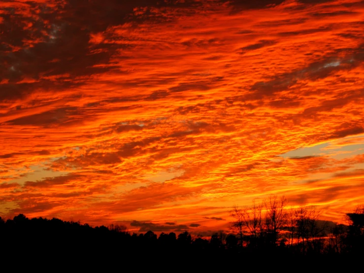 the sky is full of clouds as the sun sets