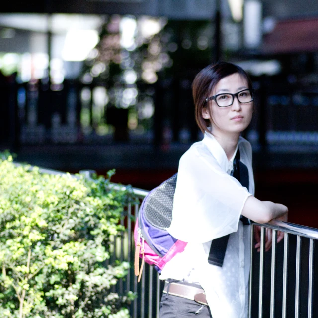 a woman on the street posing on a balcony